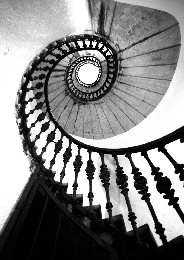 Black and white spiral staircase photograph in Budapest by Francis Keating